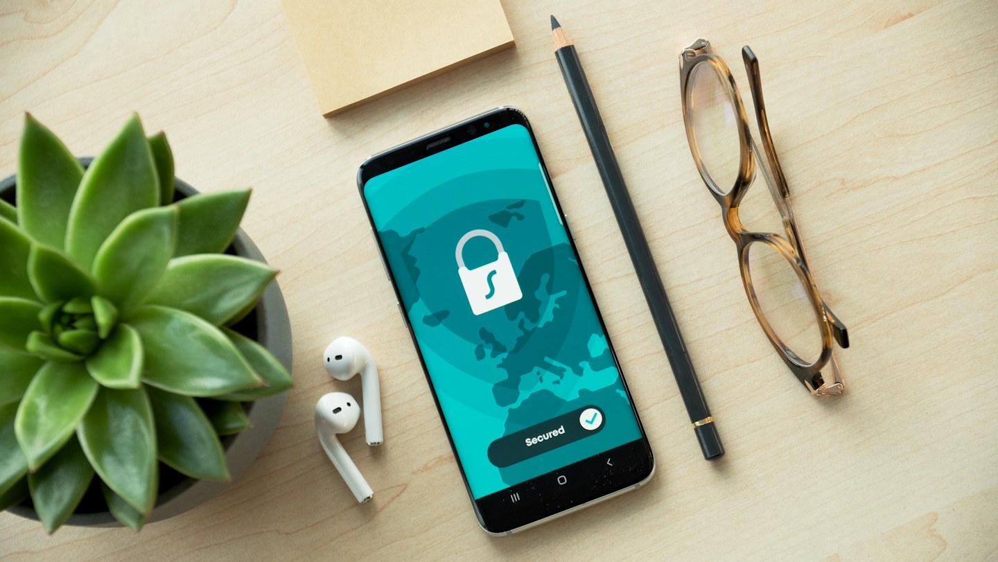 A smartphone displays a lock symbol, a reminder to protect account access.