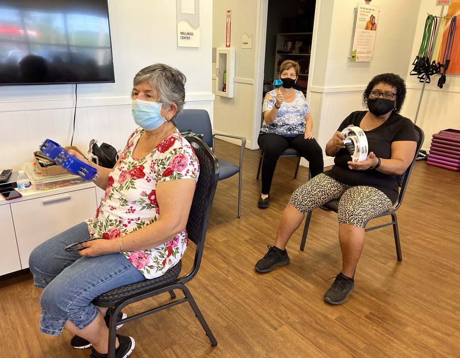Members taking part in a seated group fitness class