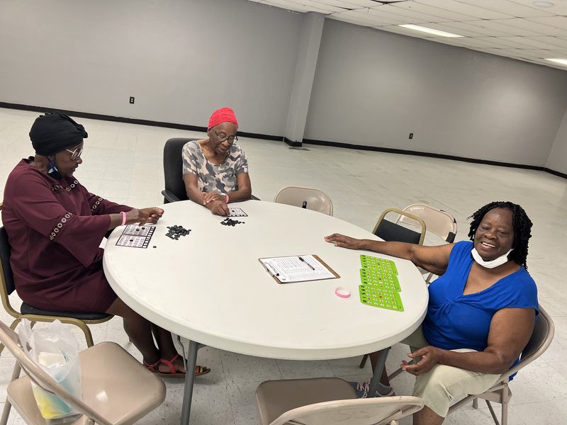 Members gathered around a table at a community event